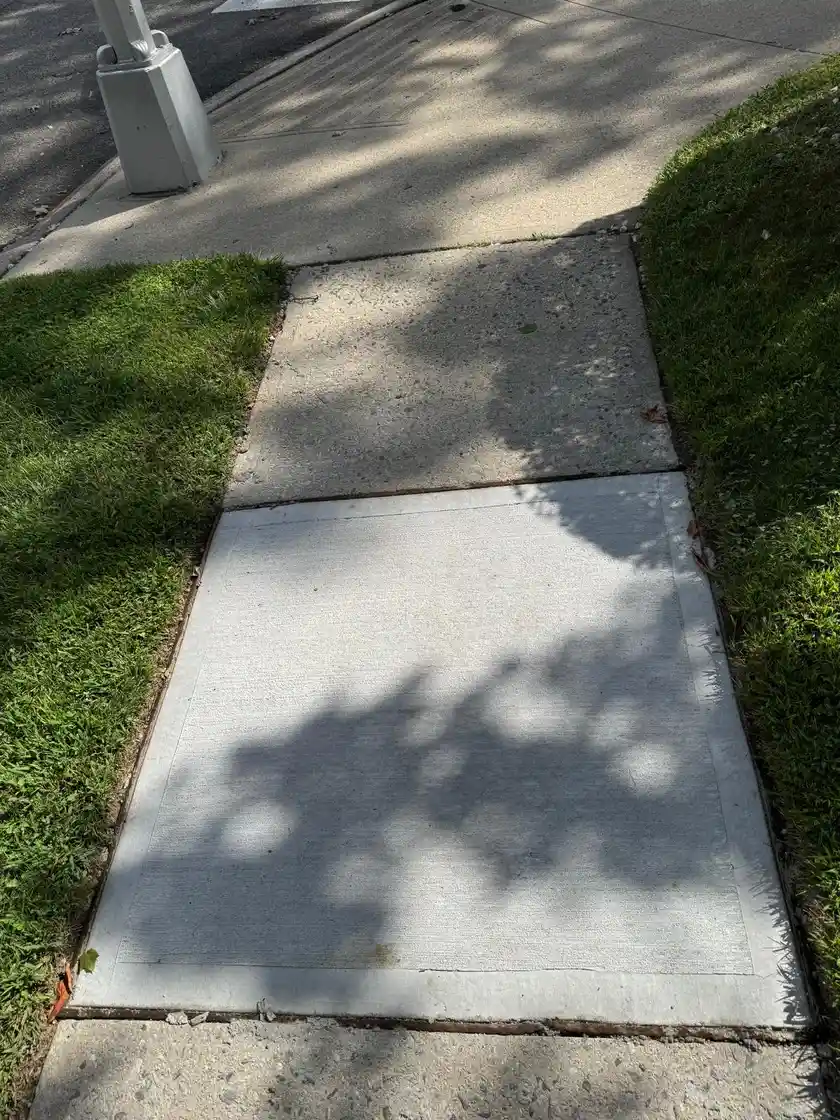 Broom-finished concrete sidewalk slab in Queens NY