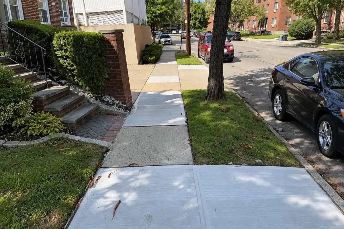 Repaired sidewalk in Whitestone, Queens NY with new concrete slabs