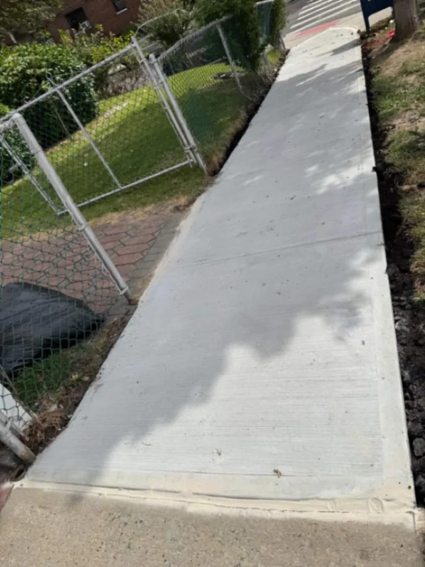 Reconstructed concrete sidewalk along a residential property in Queens ny