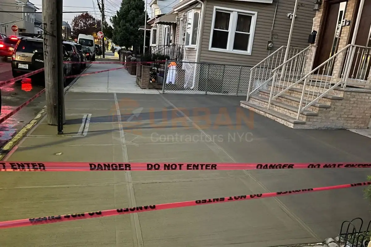 Repaired sidewalk in NYC closed with caution tape for curing